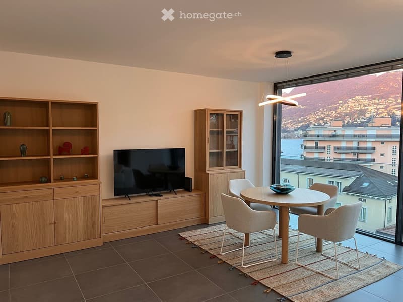 modern living room with wooden furniture, flat screen TV, dining table, and large windows