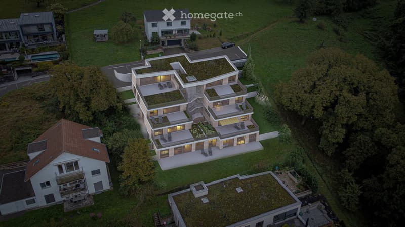 Modern multi-story house with green roofs, multiple terraces, and a swimming pool
