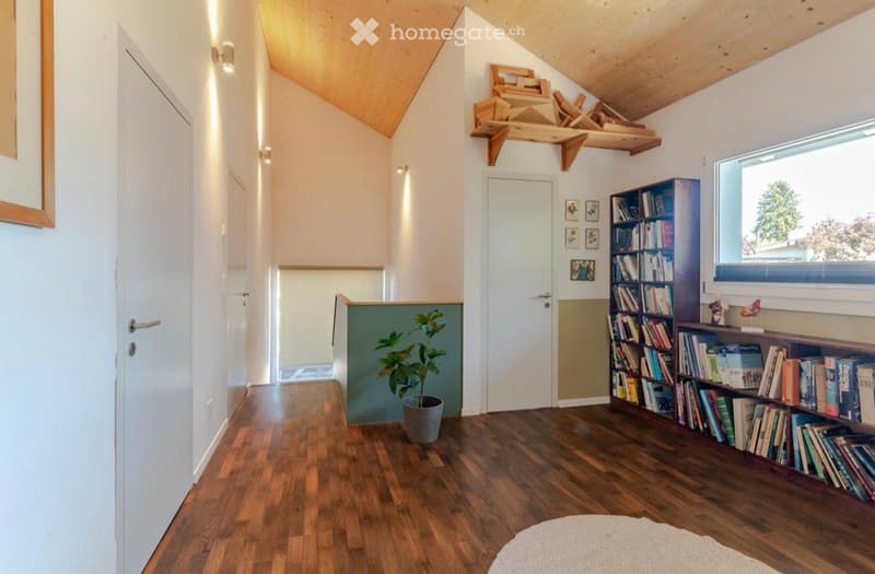 wooden floor, white walls, wooden ceiling, white doors, bookshelf, potted plant, window, picture frames, wall lights
