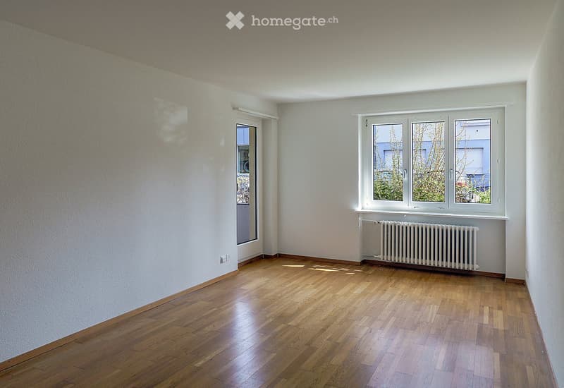 Wooden floor, white walls, radiator, glass door, windows