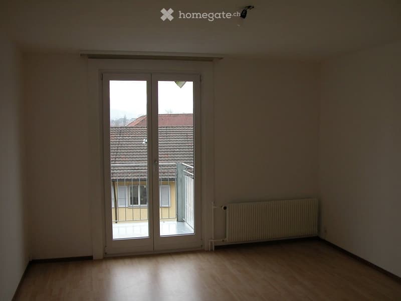 empty room, sliding glass doors, balcony, radiator, wooden floor