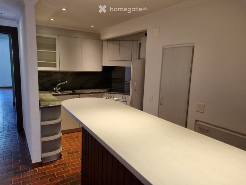 modern kitchen with white cabinets, granite countertops, island, sink, faucet, refrigerator, oven, tiled floor