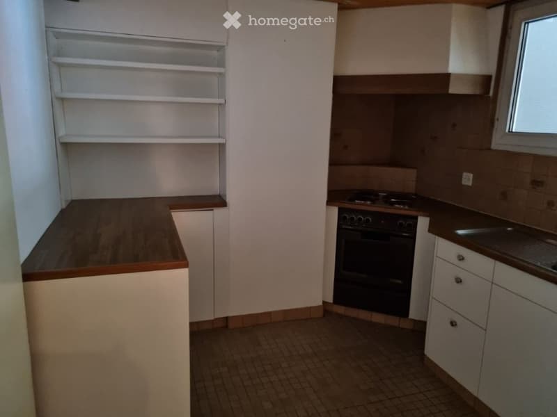 kitchen with white cabinets, wooden countertops, tiled floor, gas stove, oven, sink, window