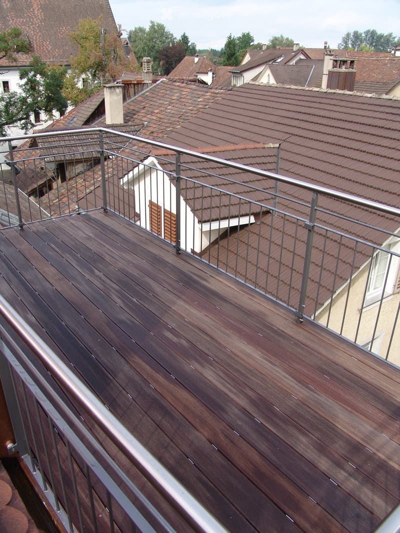 Wooden floor, metal railings, brown roof