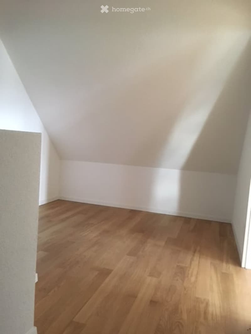 empty room, wooden floor, white walls, slanted ceiling