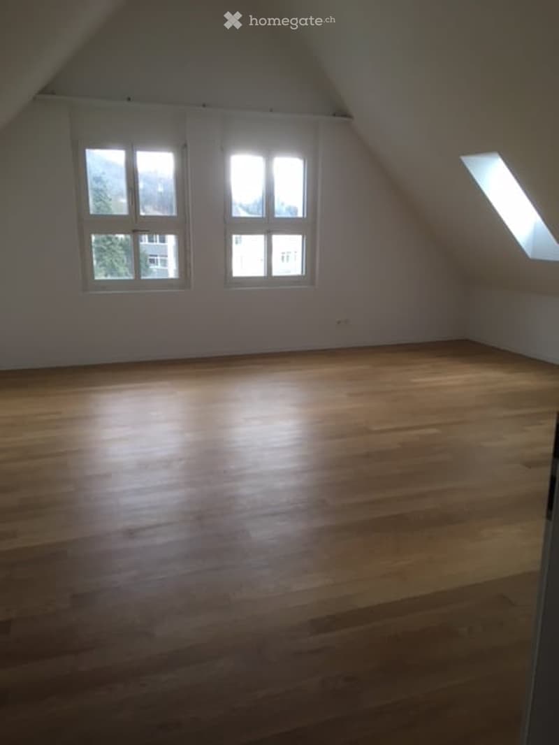 empty room, wooden floor, white walls, two windows, slanted ceiling