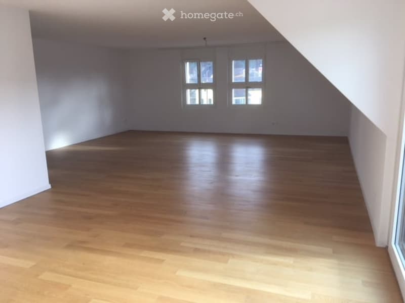 empty room, wooden floor, white walls, two windows, slanted ceiling