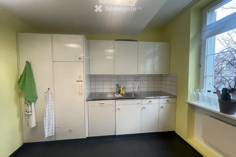 white cabinets, stainless steel sink, dishwasher, yellow walls, black floor