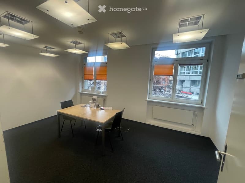 empty room with a table, chairs, windows, and ceiling lights