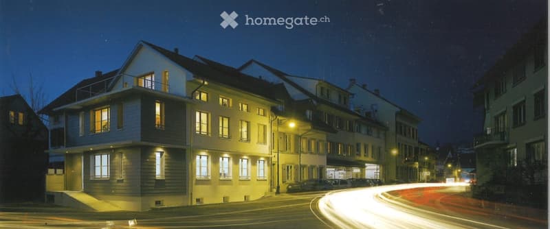 3 story house, white exterior, multiple windows, balcony, street lights, cars parked