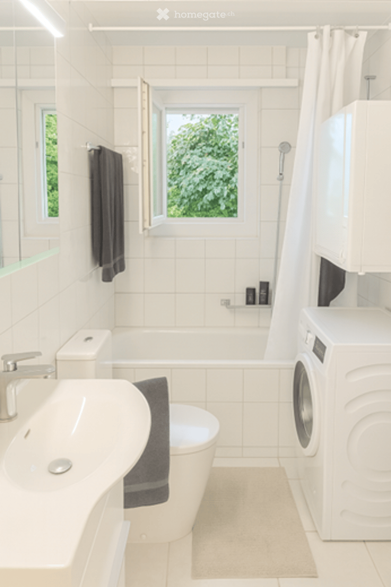 white tiles, white sink, white toilet, bathtub, washing machine, window