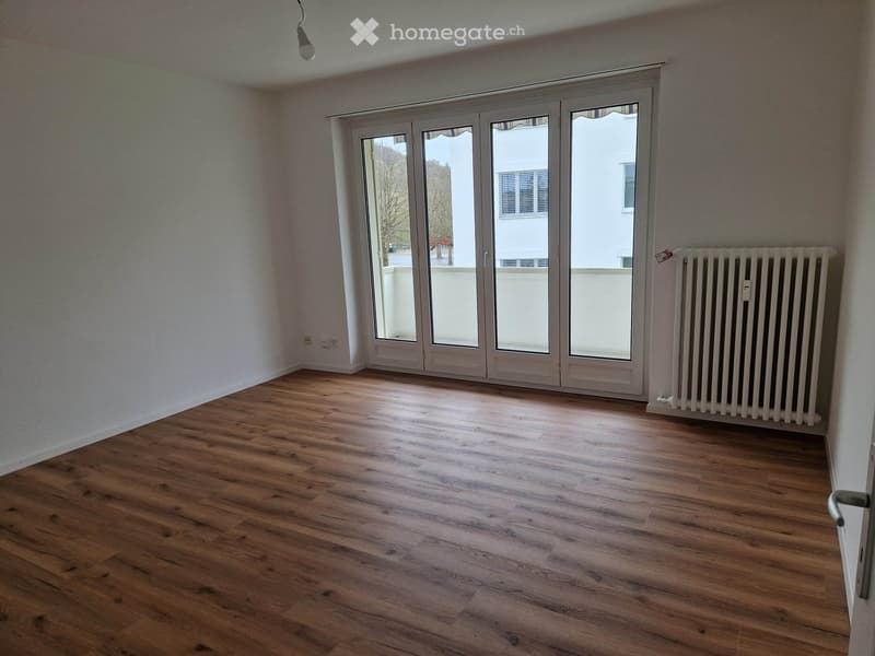 empty room, wooden floor, white walls, sliding glass doors, balcony, radiator