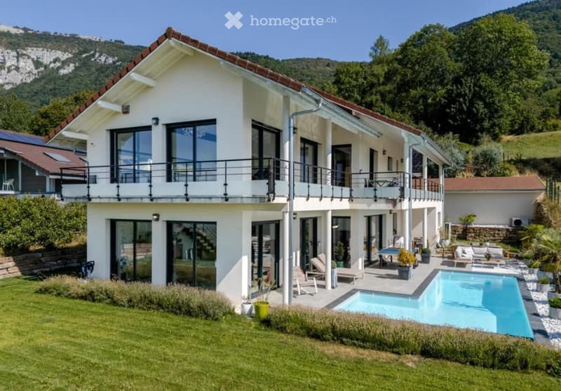 2 story house, white exterior, brown roof, large windows, balcony, swimming pool, green lawn, mountain view