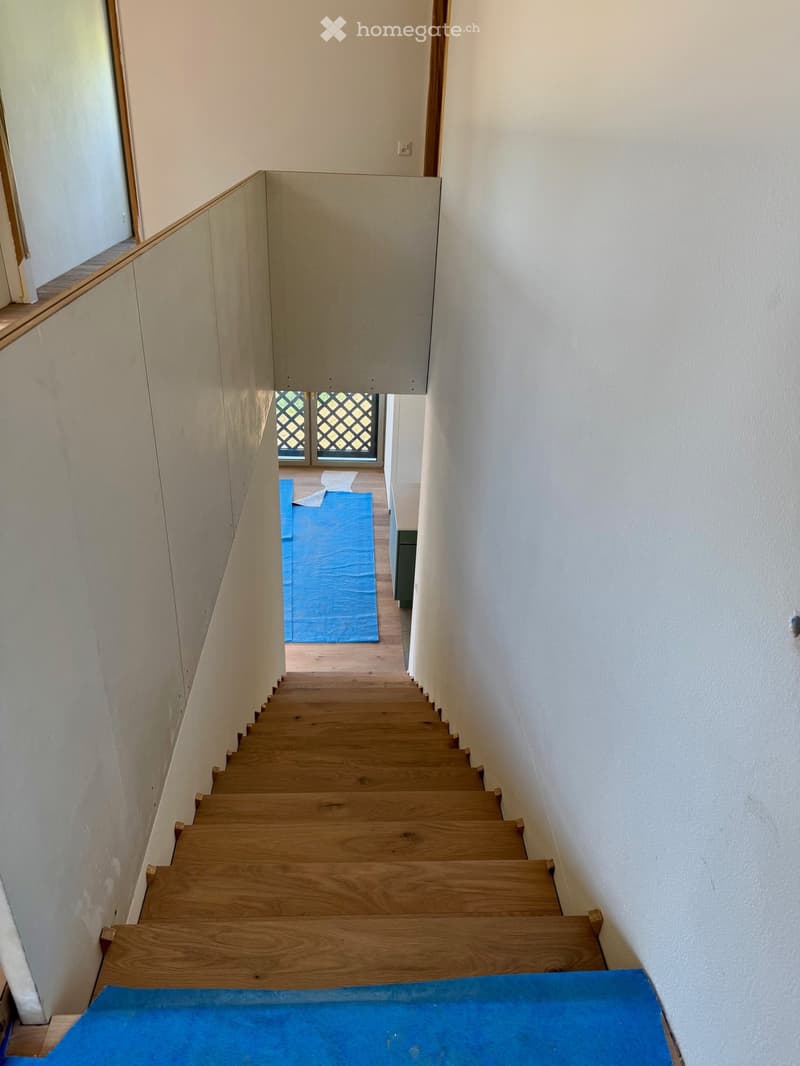 wooden steps, white walls, blue tarps