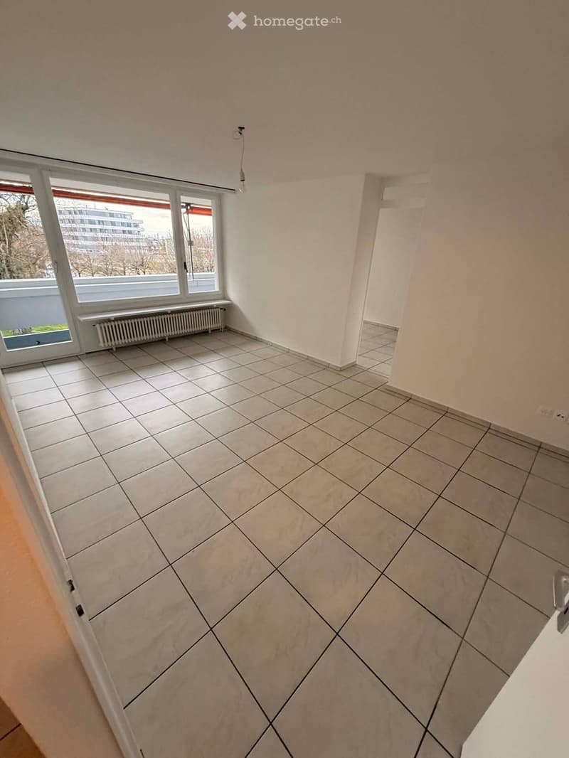 empty room, white tiles, large window, balcony, white walls, white ceiling, white radiator