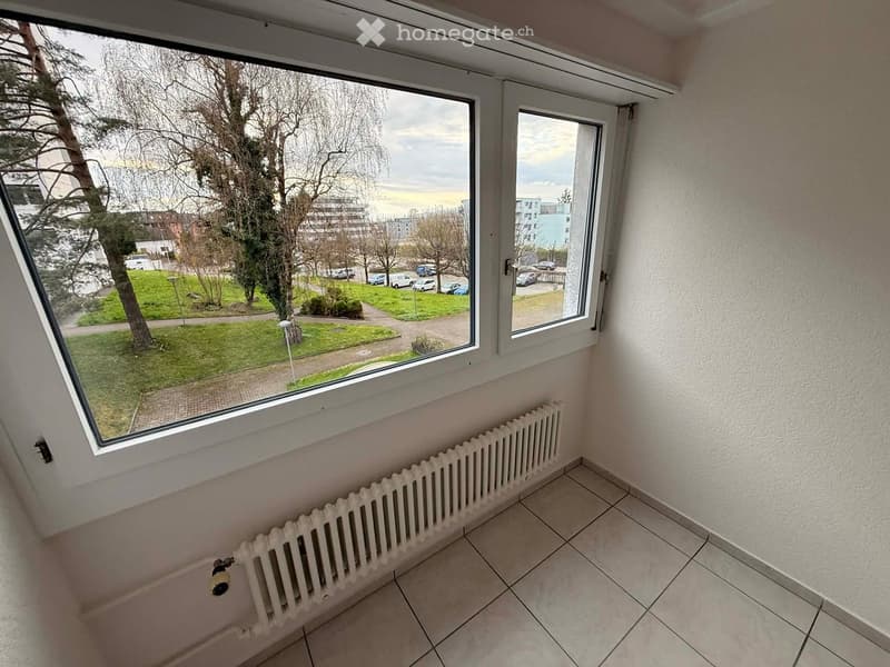 empty room, large window, white radiator, tiled floor