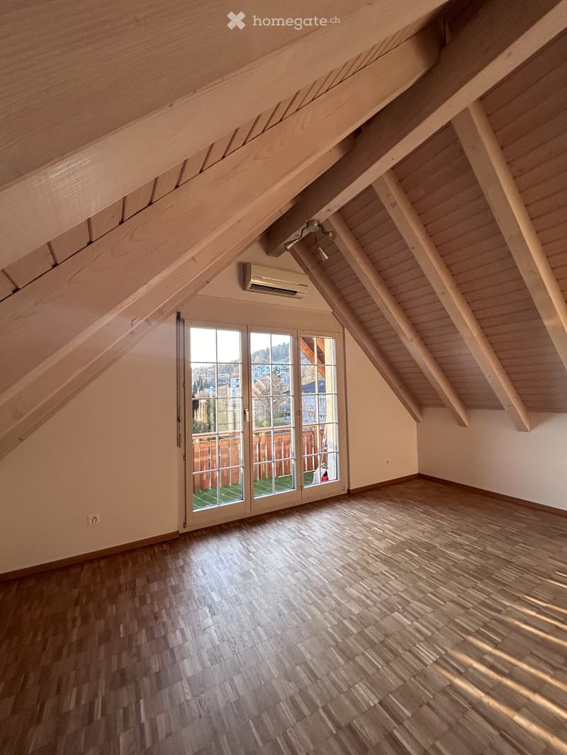 Wooden staircase with a window overlooking an outdoor area, featuring a modern design with wooden railings and a sleek air conditioning unit mounted on the wall.