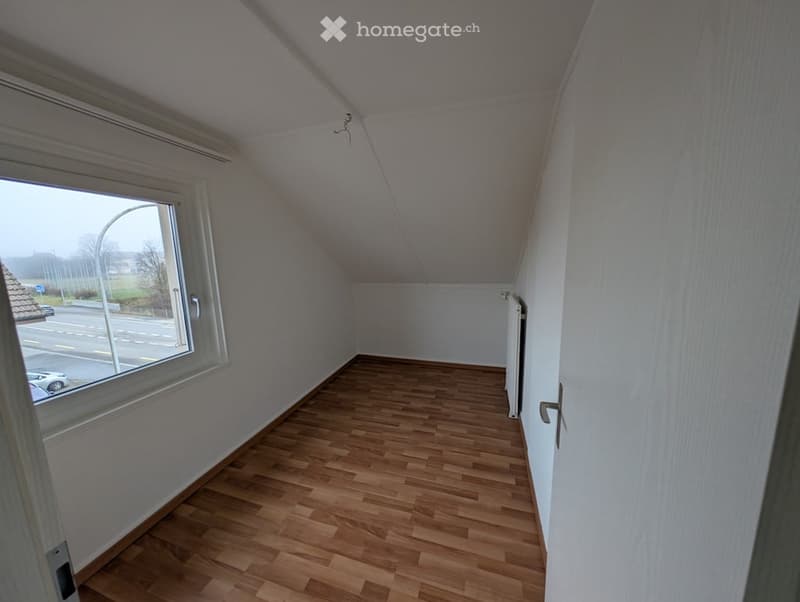 empty room with a window and wooden floor