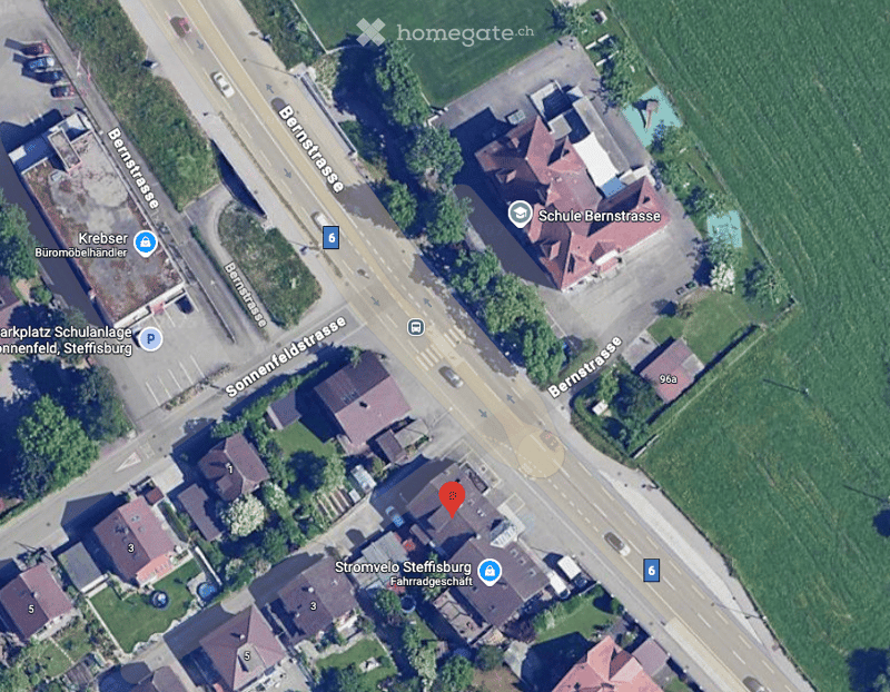 Aerial view of an intersection with several houses and green fields, labeled house number 3 marked with a pin