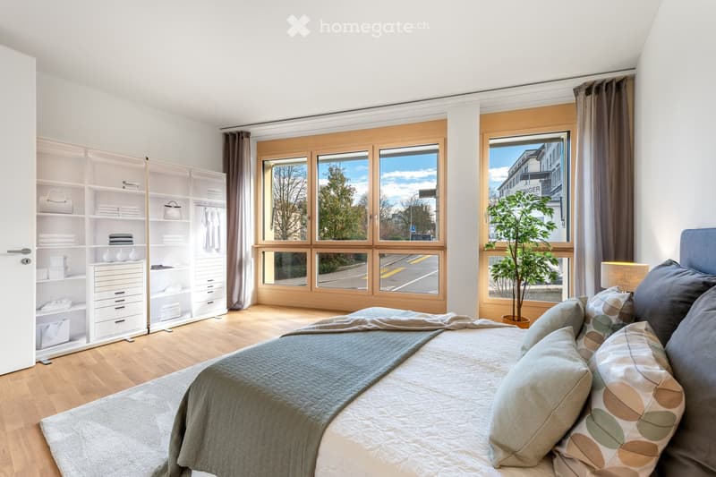 large bed, white bedding, large windows, wooden floor, white wardrobe, potted plant