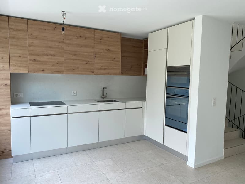 modern kitchen with wooden cabinets, white countertops, built-in oven, induction cooktop, sink, faucet, tiled floor