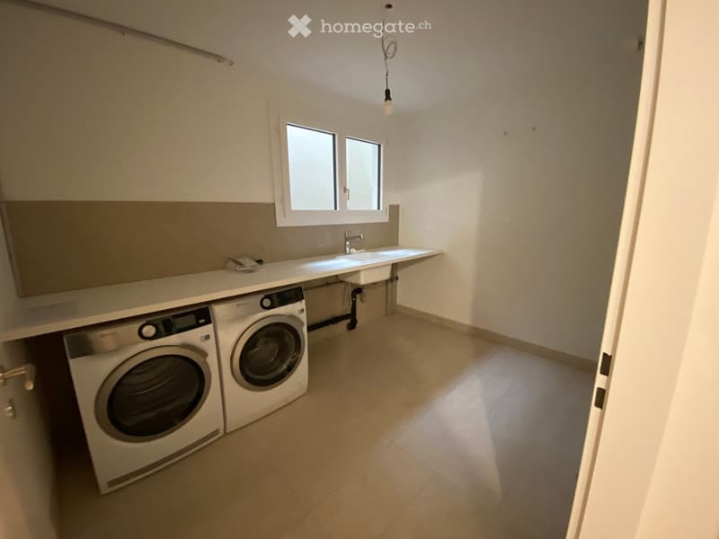 Laundry room with washing machine, dryer, sink, and window
