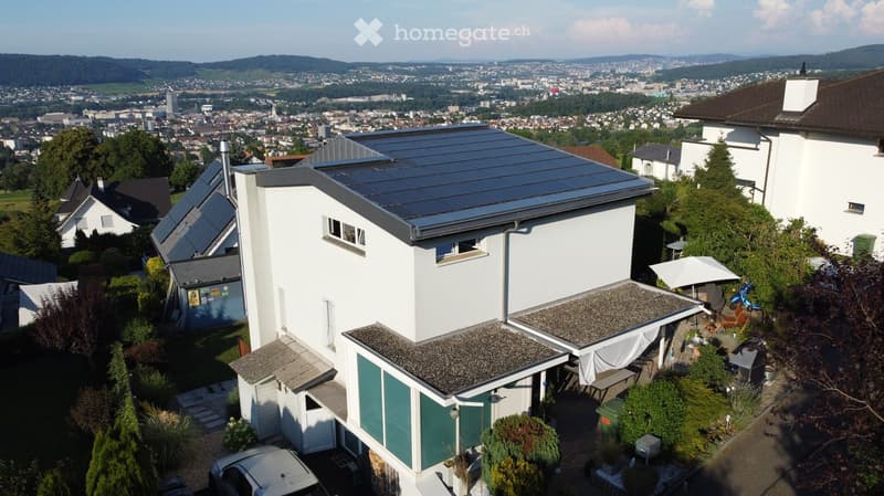 2 story house, white exterior, solar panels, city view, green landscape, patio with umbrella