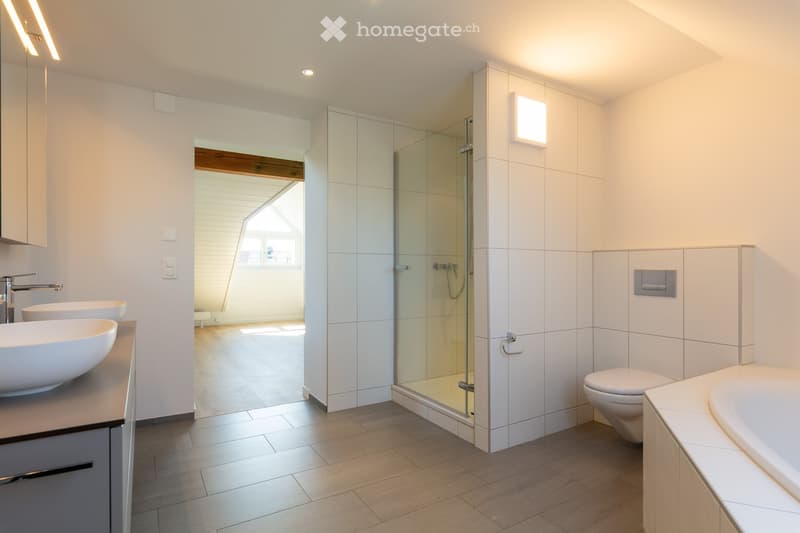 modern bathroom with white tiles, glass shower, white sink, toilet, bathtub, wooden floor