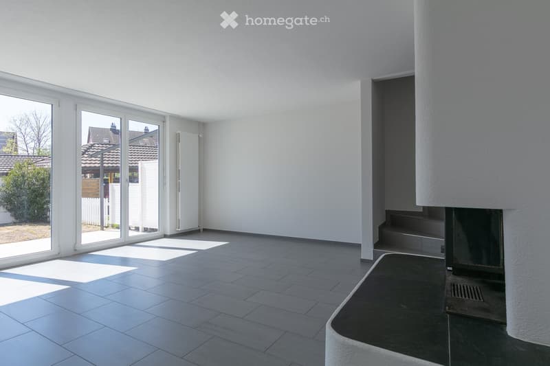 empty room, white walls, gray floor, sliding glass doors, fireplace