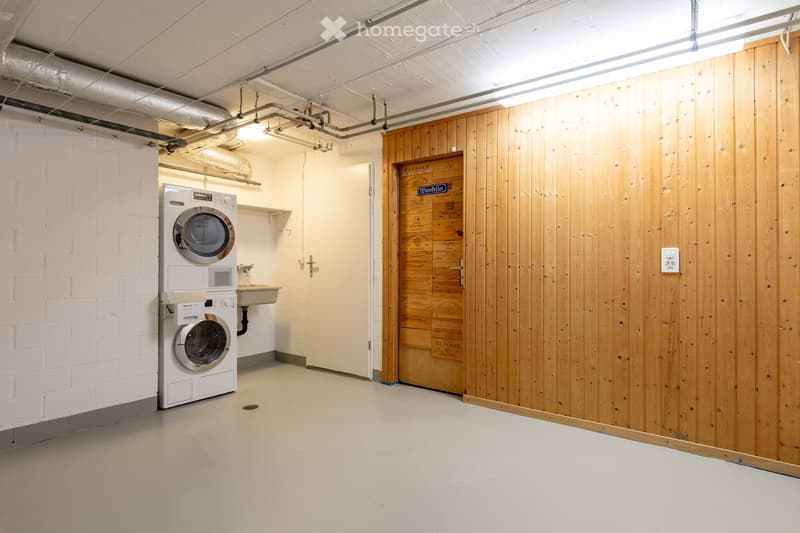 Laundry room with a washing machine and a sink