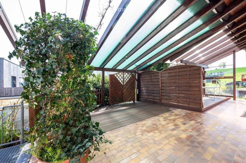 covered terrace with wooden pergola, wooden floor, brick floor, wooden gate, potted plant