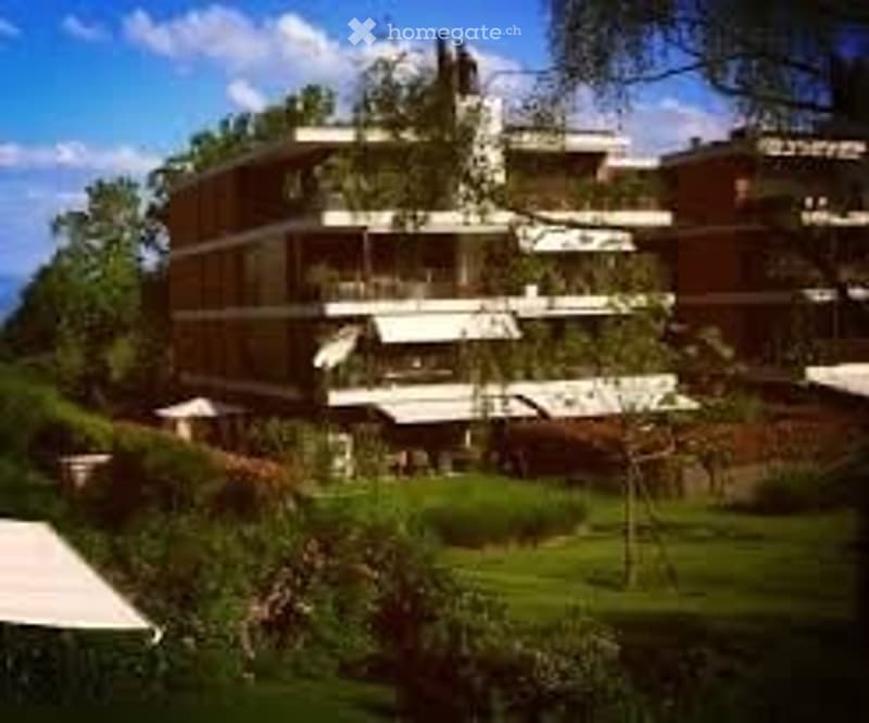3 story building, red brick, white windows, balconies, garden, trees, view