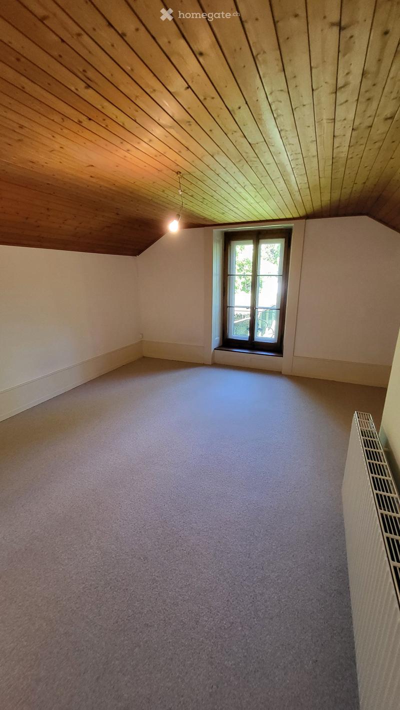 empty room, wooden ceiling, carpeted floor, window, radiator
