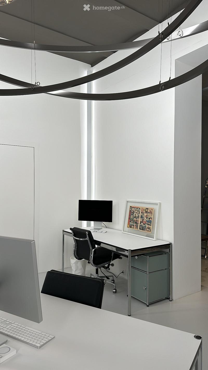 modern office room with white walls, desk, computer, chair, and framed picture