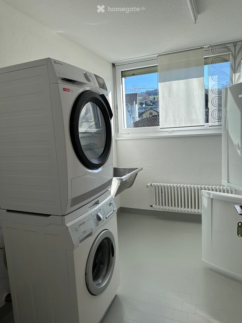 Laundry room with washing machine, dryer, and sink