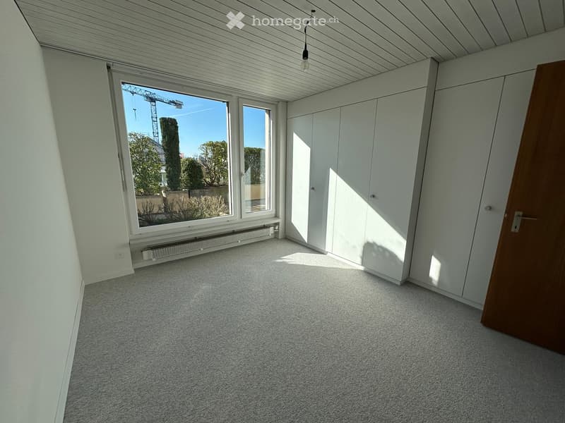 empty room, large window, white walls, white ceiling, white floor, white cabinets, radiator