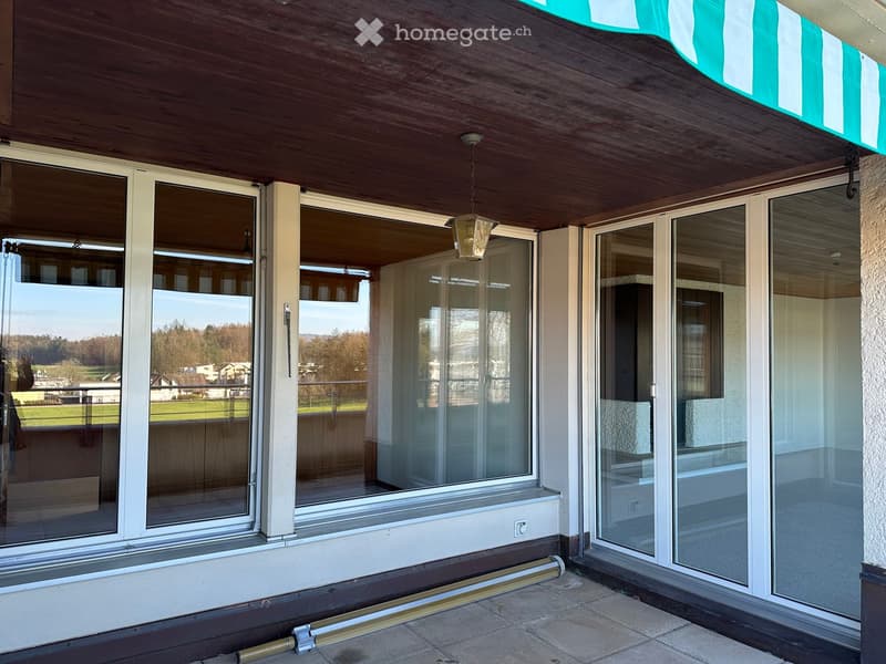 large windows, balcony, tiled floor, wooden ceiling, green landscape view
