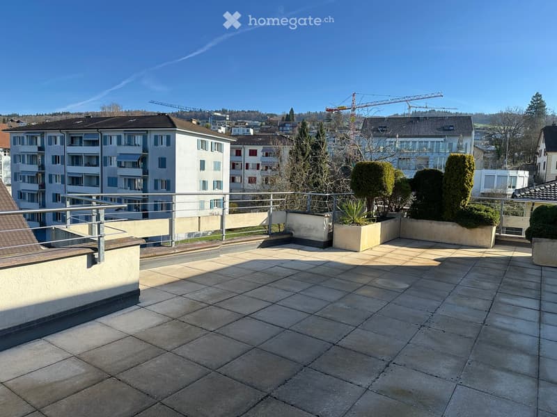 large terrace with tiled floor, metal railings, and a view of the city