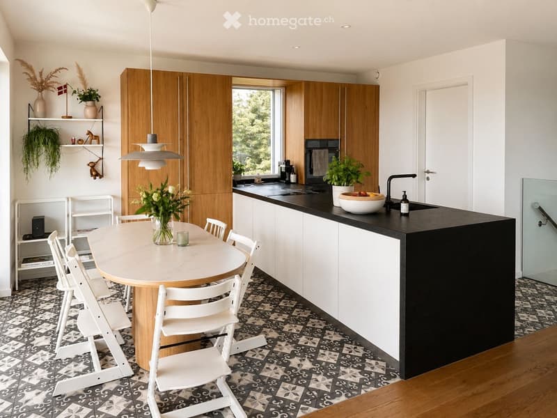 Modern kitchen with wooden cabinets, black countertops, dining table, and white chairs.