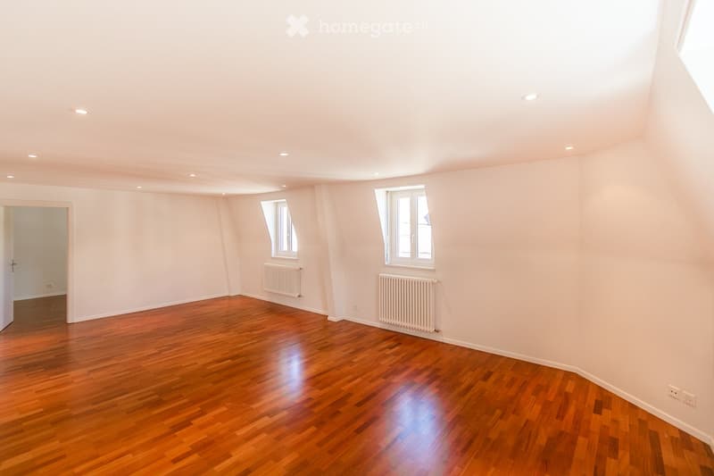 empty room, wooden floor, white walls, two windows, two radiators, ceiling lights