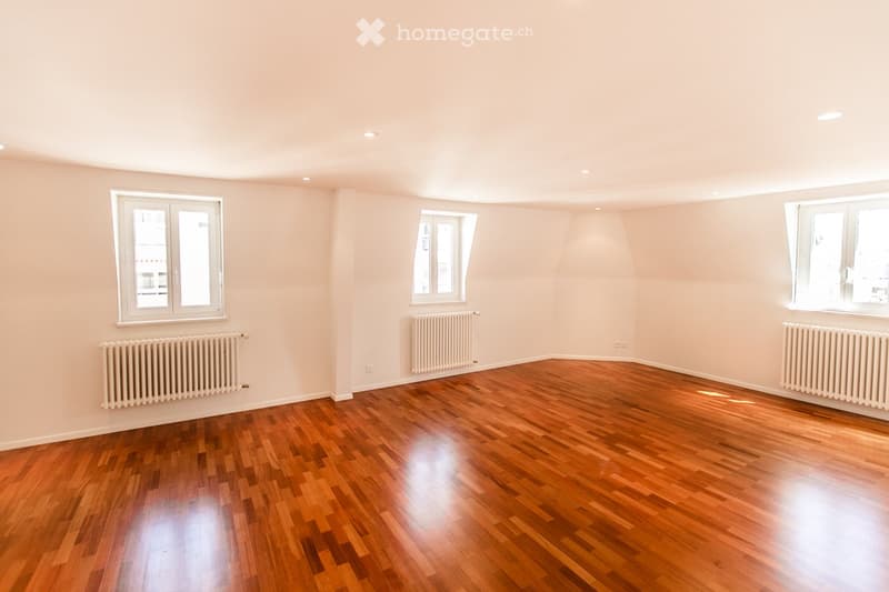 empty room, wooden floor, white walls, two windows, two radiators