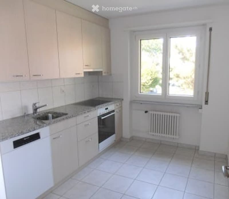 modern kitchen with white cabinets, tiled floor, sink, dishwasher, oven, window