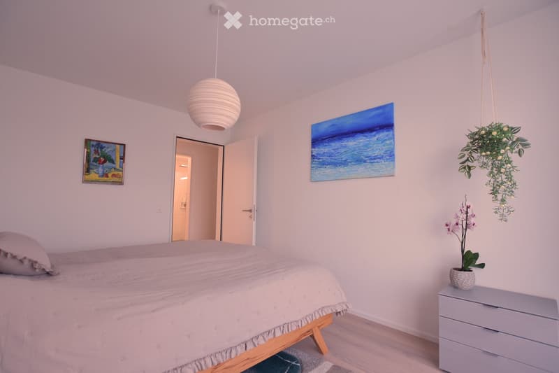 Bedroom with bed, nightstand, and artwork on the wall