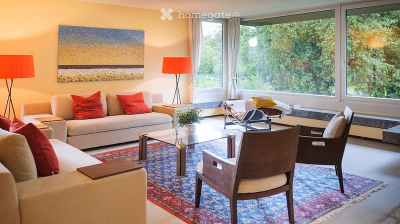 two sofas, coffee table, carpet, floor lamps, large windows, artwork, garden view