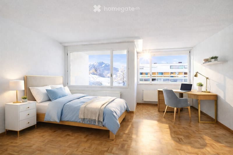 A bedroom with a bed, nightstands, desk, chair, and windows with a view of the mountains.
