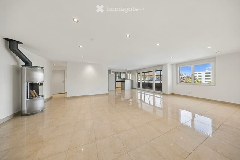 Unfurnished Room. Empty room with white walls, beige tiles, and a fireplace. Large windows provide natural light.