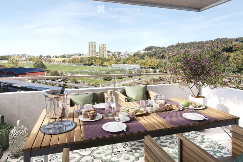 Balcony with table, chairs, and a view of the city