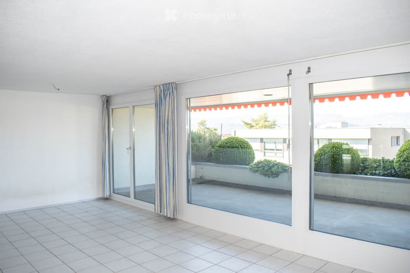 empty room, white tiles, large glass doors, balcony