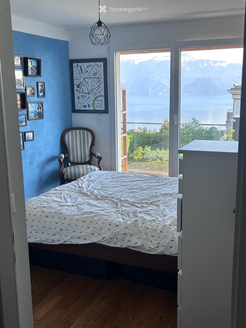 Furnished Room. Bedroom with a bed, chair, and a view of the mountains and lake.