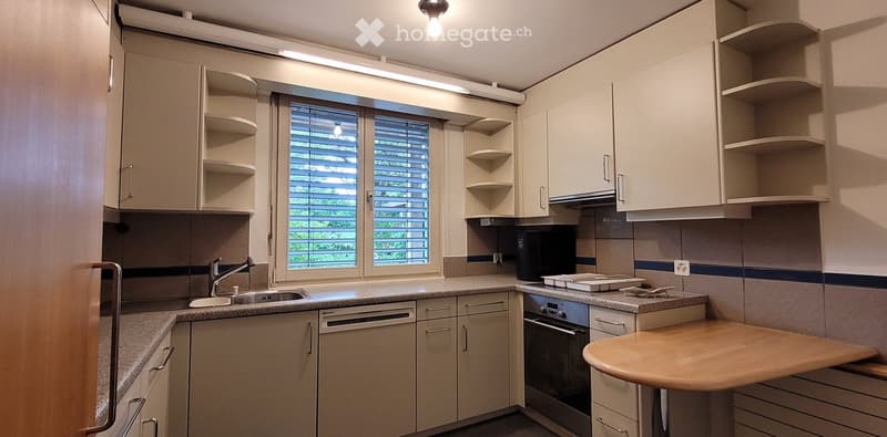 modern kitchen with white cabinets, granite countertops, dishwasher, washing machine, stainless steel appliances, window with blinds